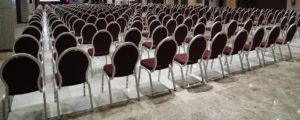 A large empty hall with all the chairs set out for a convention