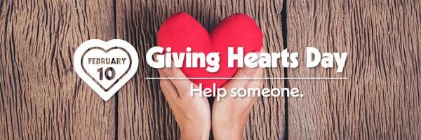 Two hands holding a red heart.  Text is Giving Hearts Day - Help Someone.  White heart with February 10 in the middle of the heart.