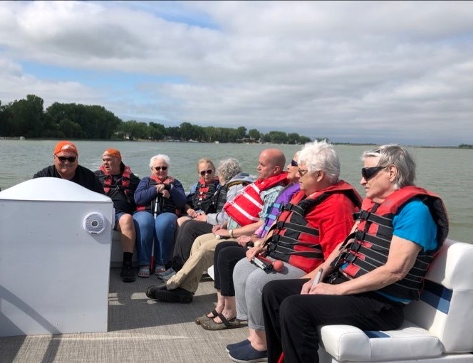 Campers sitting on a pontoon enjoying a day on the lake.