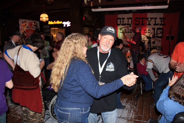 Michelle is dancing at Saloon 10 with Charlie (a volunteer)